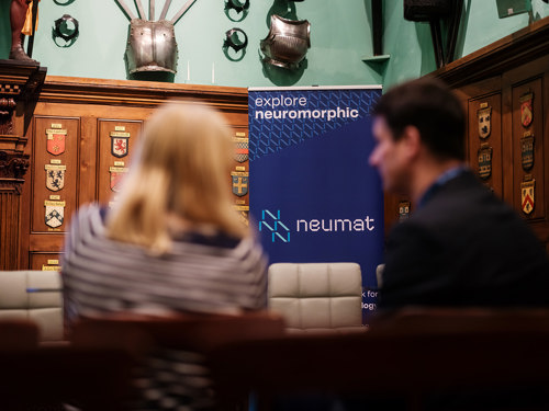 Image of meeting participants and NeuMat banner